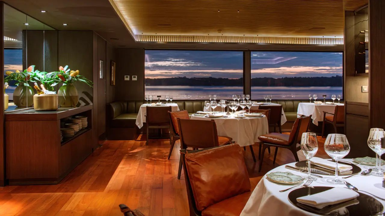 The dining room set for dinner, with views of the river