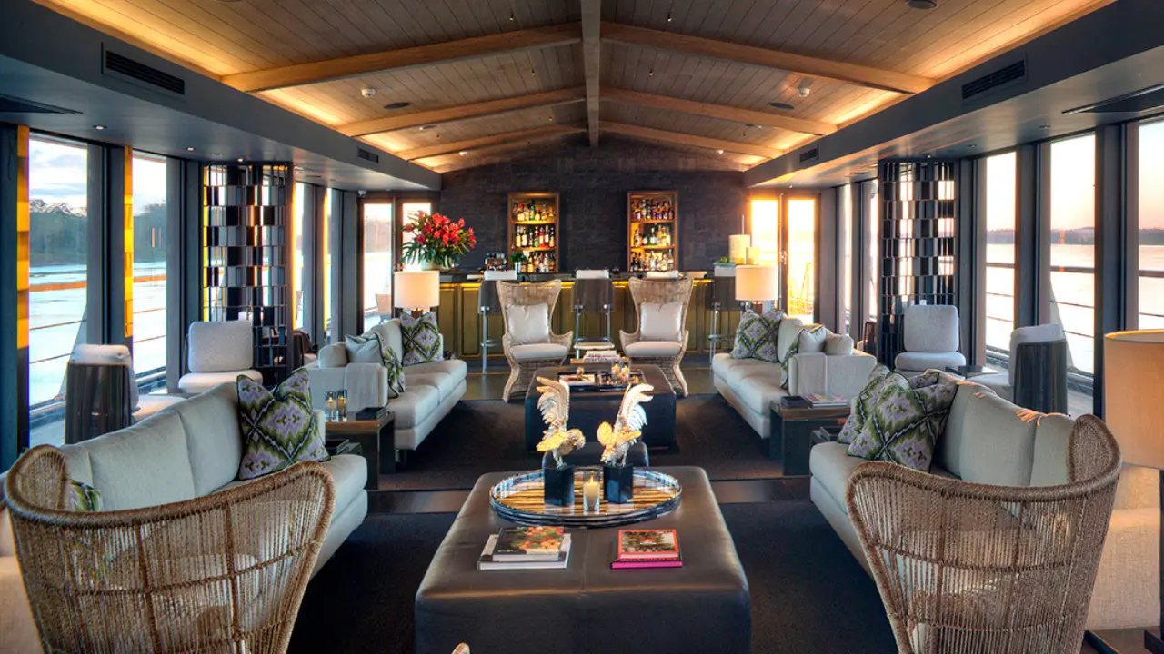 The lounge, with wicker armchairs and windows on both sides