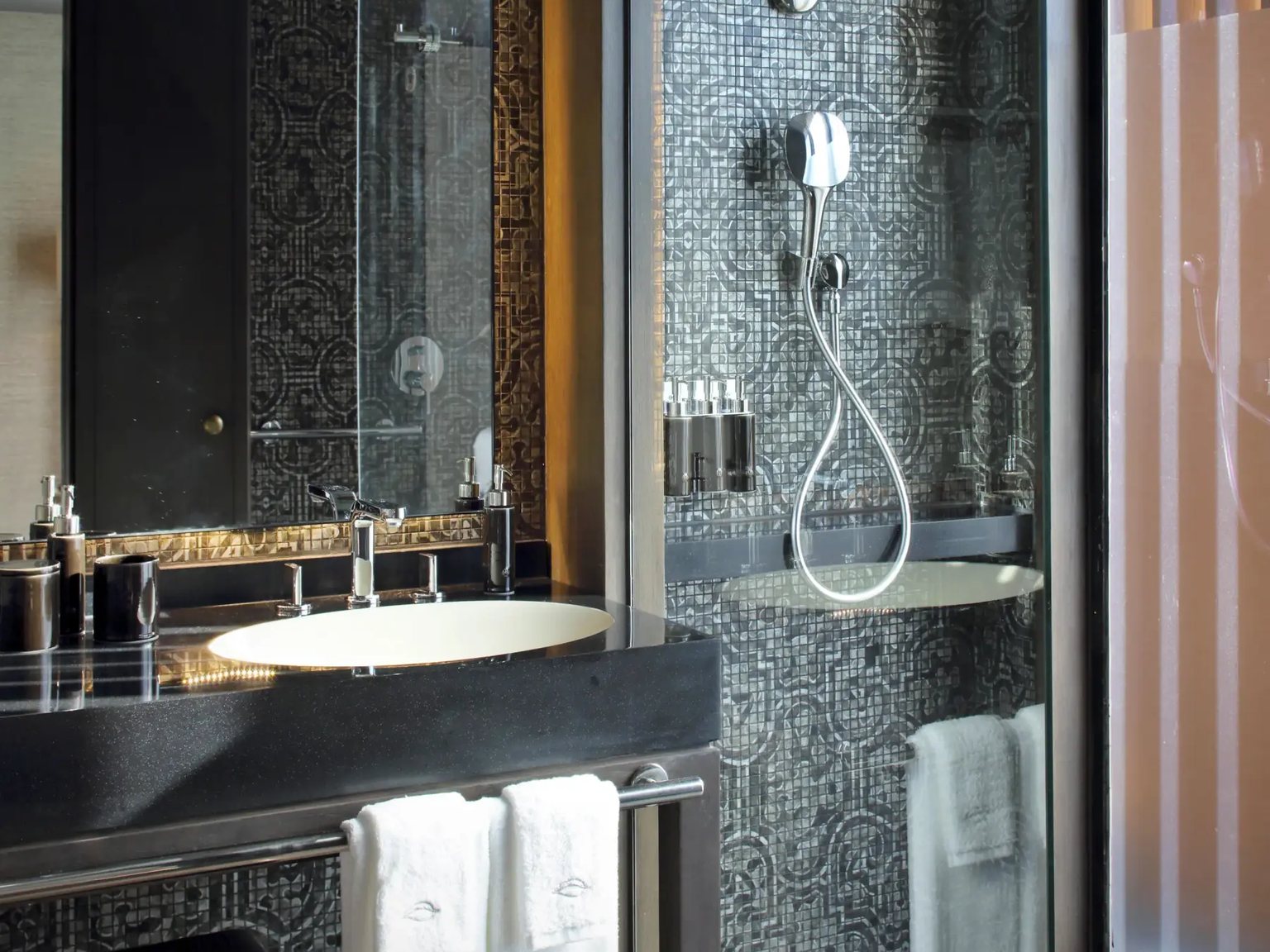 A suite bathroom with a walk-in rain shower