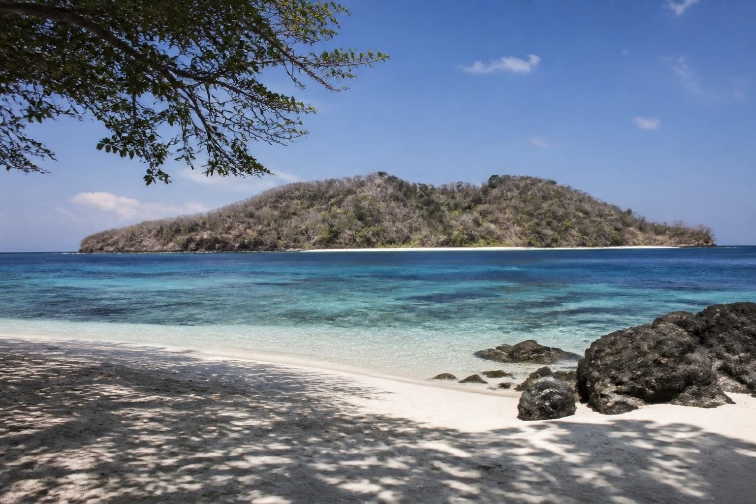White sand and clear turquoise water at Valu Beach, looking across the channel to Jaco Island, eastern Timor-Leste