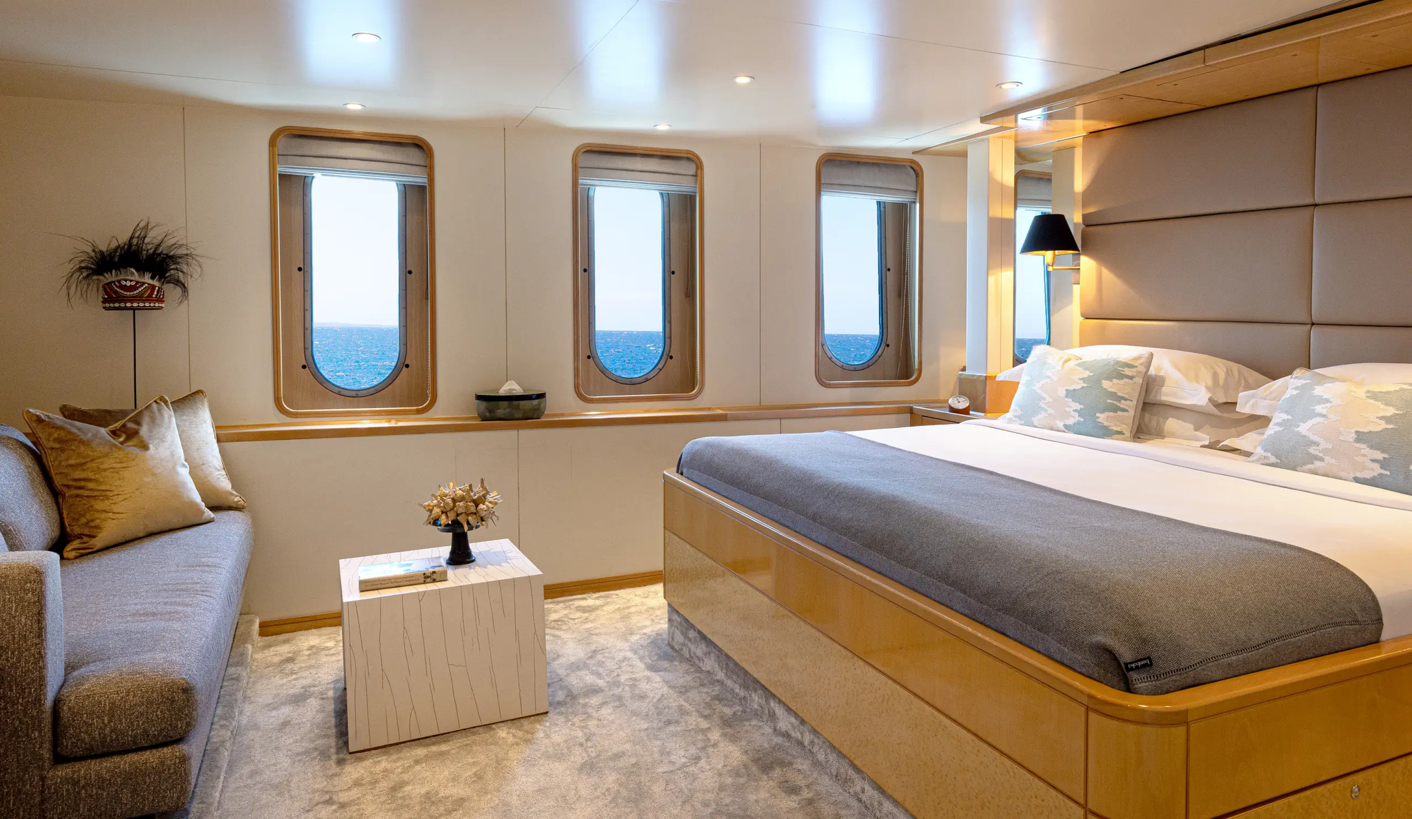 Cabin 201, Category II, with a king bed, a sofa and three tall windows