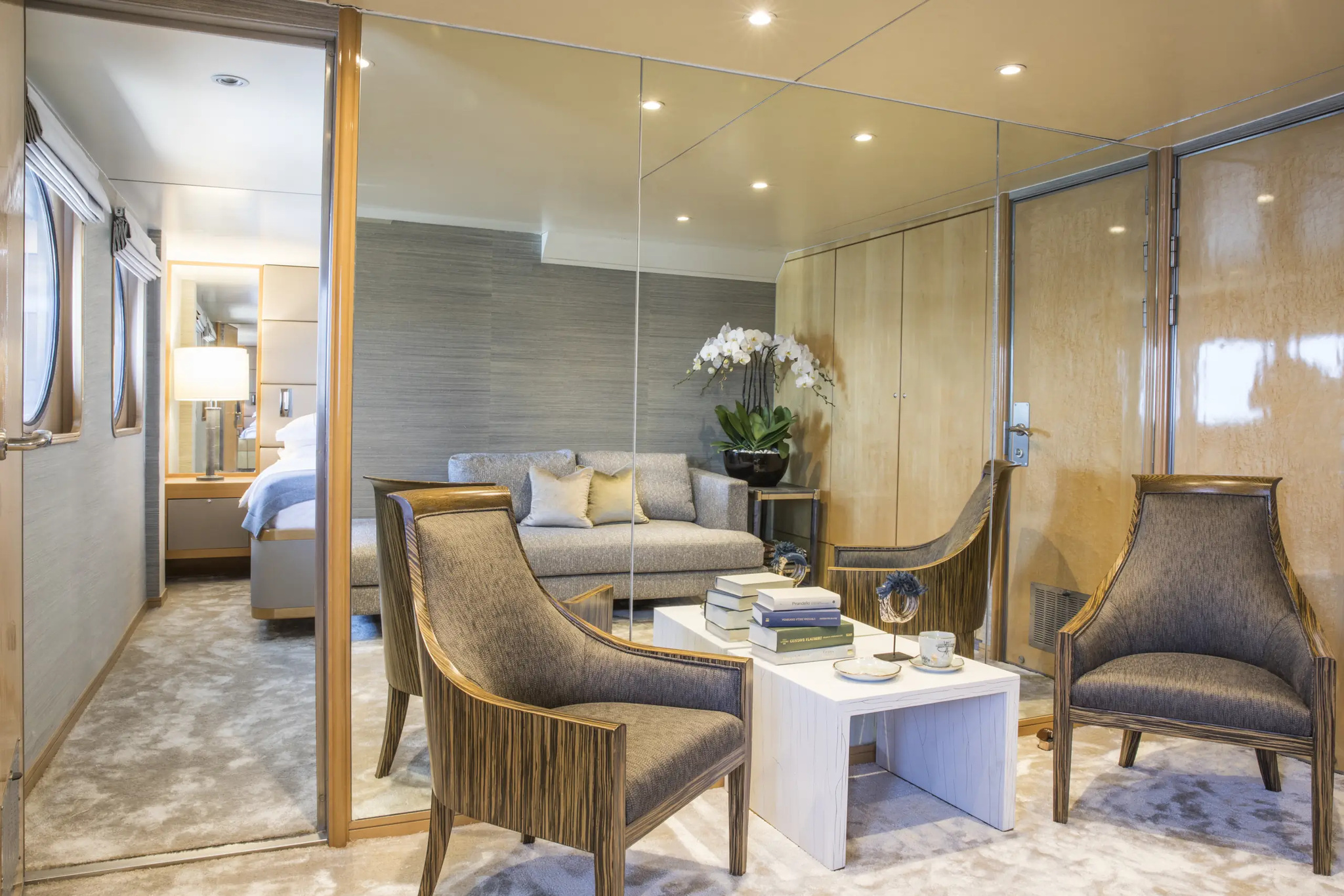 The sitting area of cabin 402, behind a glass partition from the bedroom
