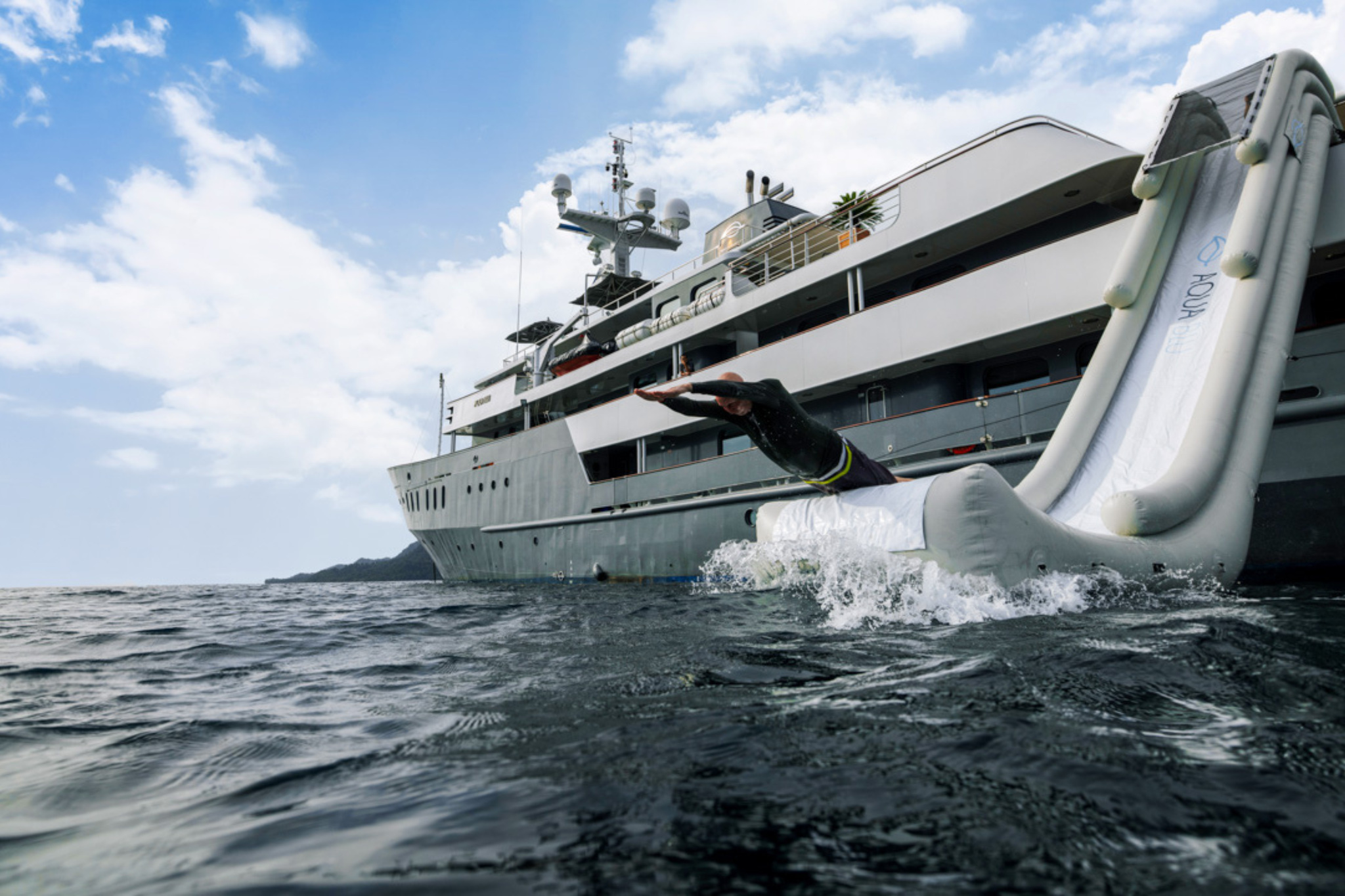 A swimmer splashing down at the foot of the ship's inflatable slide
