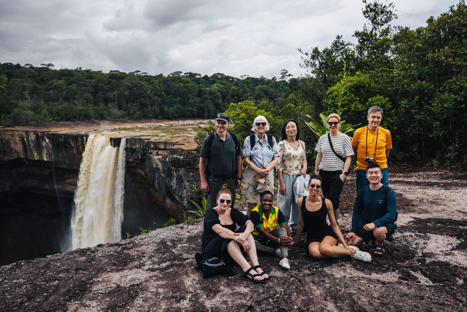 A Waypoint Journeys group with their guide at the lip of Kaieteur Falls, Guyana